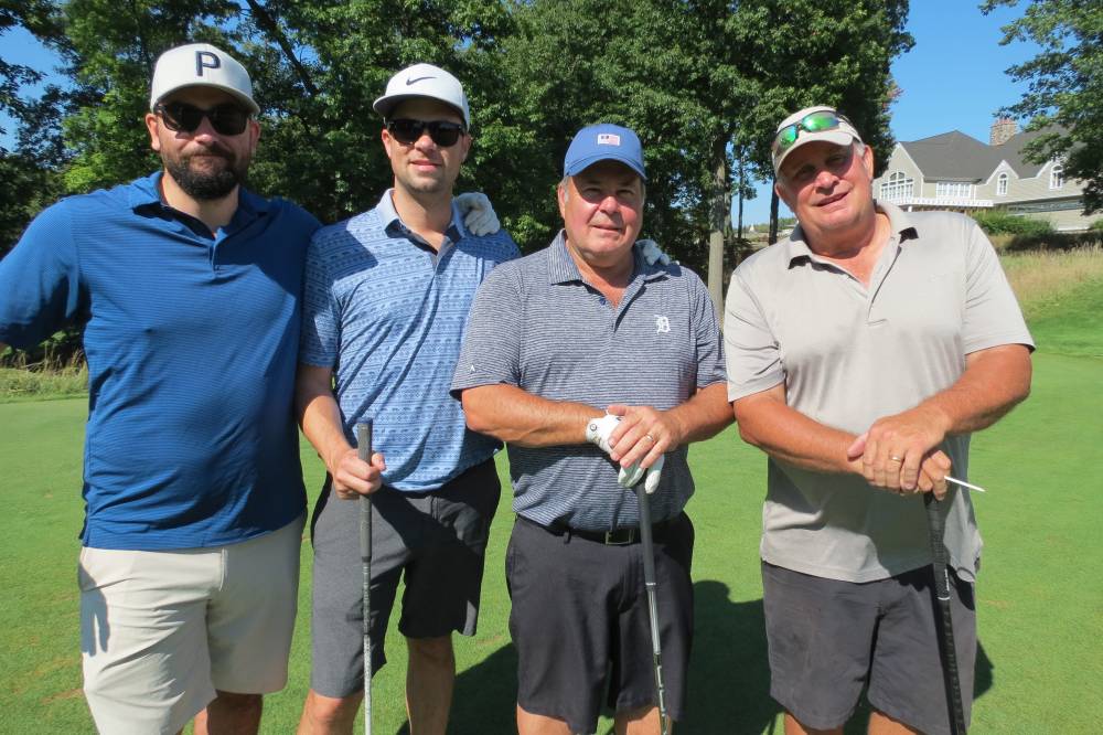 Four golfers posing